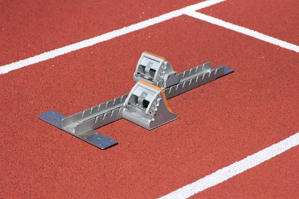 Athletics starting blocks on race red track — Stock Photo, Image