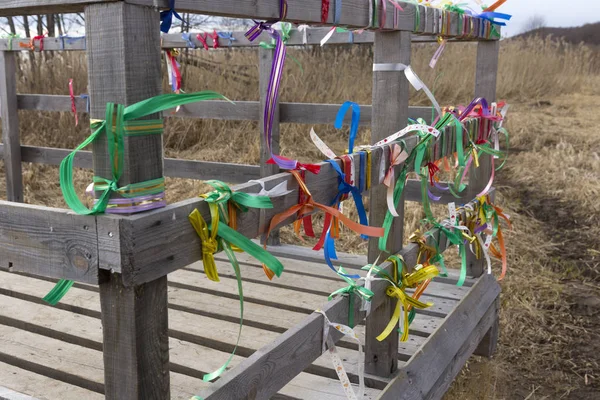 Bridge desires railing tied with colored ribbons — Stock Photo, Image