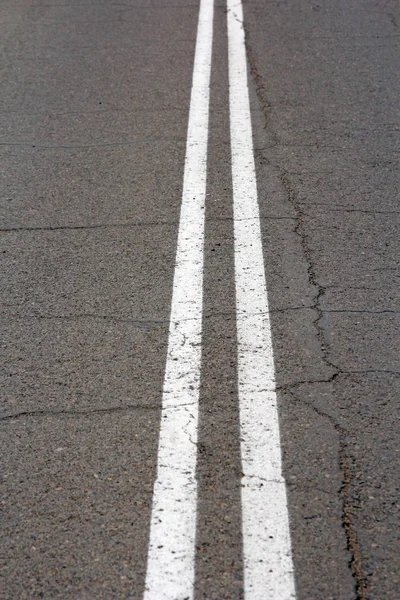 Texture of an asphalt road with a top view of a double white strip — Stock Photo, Image