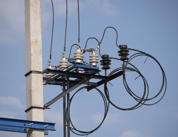 Electric transformer with wires and an insulator against the sky
