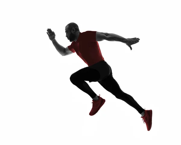 Silhouette of sports man running — Stock Photo, Image