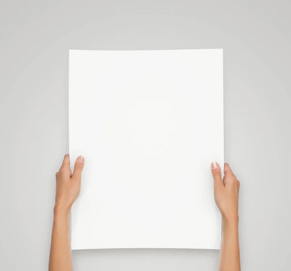 Hands holding blank paper sheet — Stock Photo, Image