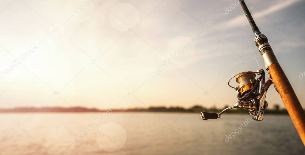 Close up of a fishing rod at the sunset