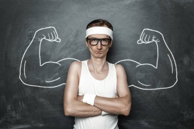 Funny sport nerd with fake muscle drawn on the chalkboard clipart