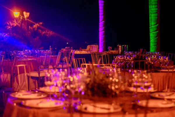 Sirvió mesas en el banquete en tonos púrpura. Foto de noche . —  Fotos de Stock