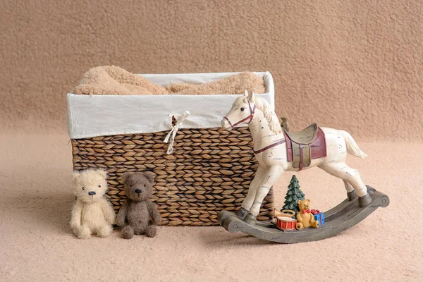 Background for shooting newborns. Brown basket decorated with toys. — Stock Photo, Image