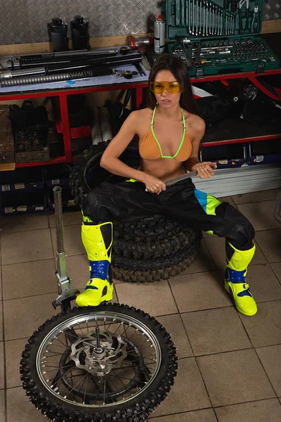 Sexy girl in garage with bike tires