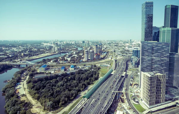 Aerial panoramic view of Moscow with TTK road and Moskva River, Russia. Moscow skyline in summer. Skyscrapers of Moscow-City in the right. Toned panorama of Moscow with modern buildings from above.