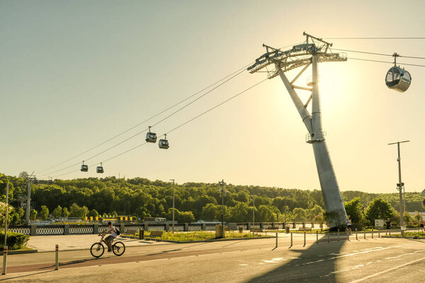 Urban new cable car in Luzhniki park, Moscow, Russia. Cableway cabins hang over Moskva River between Sparrow Hills and Luzhniki Stadium in summer. Scenic sunny view of Luzhniki Embankment in Moscow.