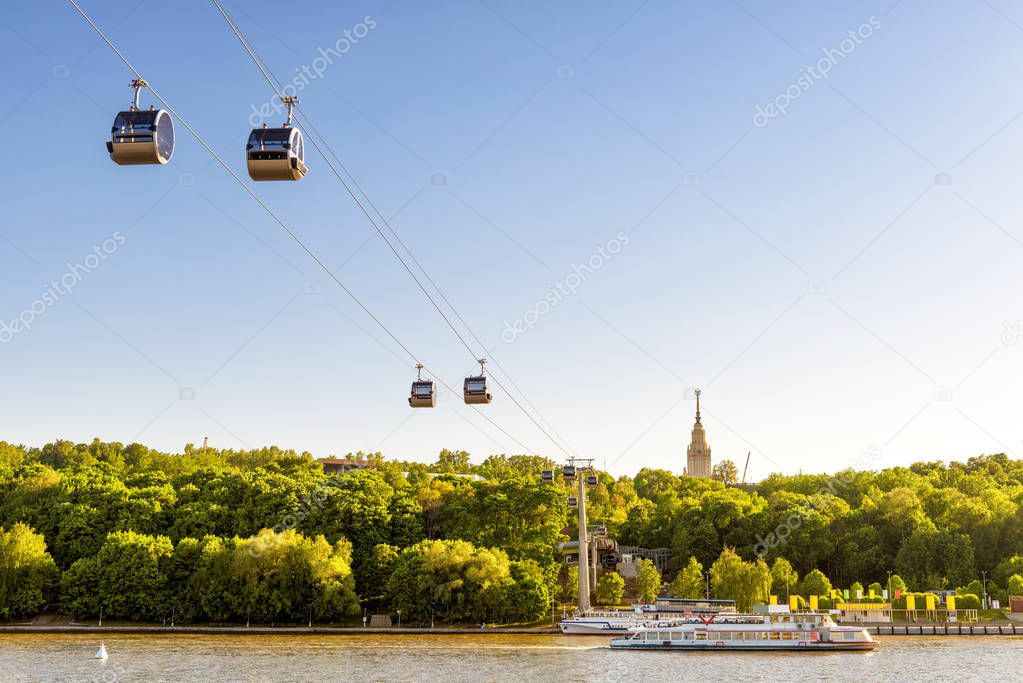 Beautiful panorama of Moscow, Russia. Scenic view of the cable car between Sparrow Hills and Luzhniki Stadium in Moscow. Cableway cabins hang in the sky over Moskva River at Moscow Luzhniki park.
