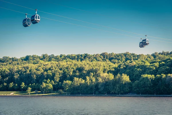 Scenic view of the cable car between Sparrow Hills and Luzhniki Stadium in Moscow, Russia. Cableway cabins hang in the sky above Moskva River in Moscow. Luzhniki park is a sport landmark of Moscow.