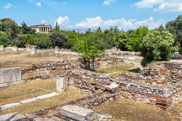 Ruins of the ancient Greek Agora, Athens, Greece. It is one of the main tourist attractions of Athens. Scenic panoramic view of the Agora of Athens with the Temple of Hephaestus in the distance.