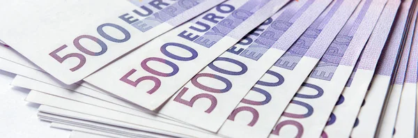 500 euro money banknotes on a white background. Horizontal banner with five hundred notes of European Union currency. Stack of euro money cash close-up. Concept of bank, stock and wealth.