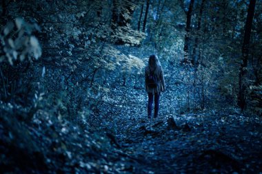 Gizemli karanlık ormanda tek başına yürüyen bir kadın. Yalnız yetişkin. 