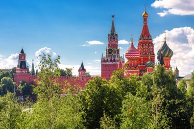 Moskova Kremlin ve St. Basil Katedrali yazın, Rusya. Moskova Kremlin 'in yeşil ağaçların arkasındaki manzarası, Moskova' nın antik mimarisi. Moskova şehir merkezindeki eski binaların manzarası. 
