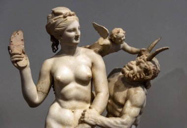 Athens - May 7, 2018: Marble sculpture of Aphrodite, Pan and Eros in National Archaeological Museum of Athens, Greece. Classical Greek statues, monument of art and history of Ancient civilization. clipart