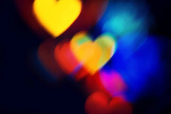 Sfocato Colorate Forme Del Cuore Bokeh Scintillato Sfondo Scuro Natale — Foto Stock