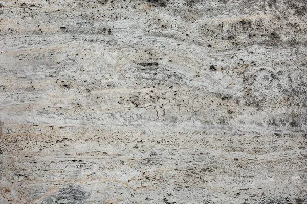 Closeup of beige porous stone textured wall