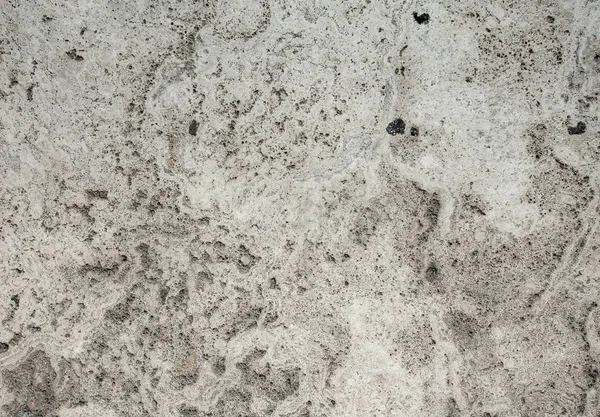 Closeup of beige porous stone textured wall