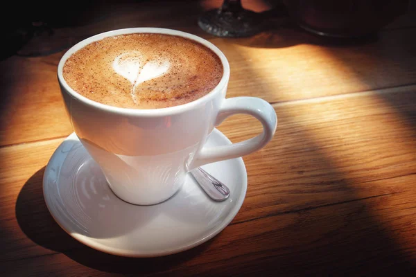 White cappuccino cup on dark brown wood background — Stock Photo, Image