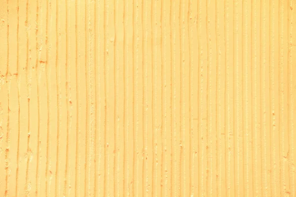 textured yellow background with plaster vertical lines and strip
