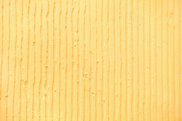 textured yellow background with plaster vertical lines and strip