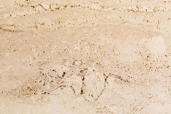 Closeup béžové porézní kamenné zdi texturou — Stock fotografie