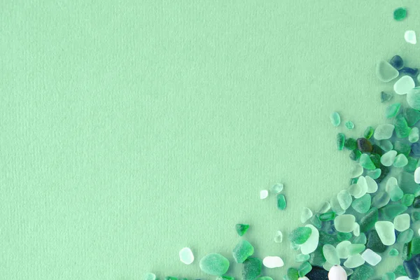 sea glass pieces on mint background
