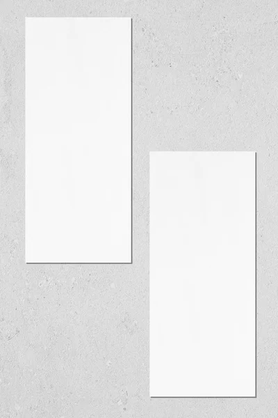 Two empty price-list or menu mockups lying on grey concrete back — Stock Photo, Image