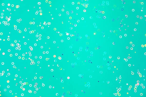 holographic foil confetti sparse on trendy mint colored backgrou