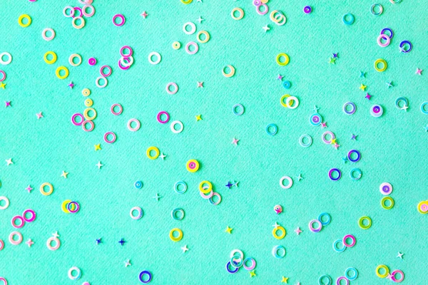 colorful foil confetti sparse on trendy mint colored background