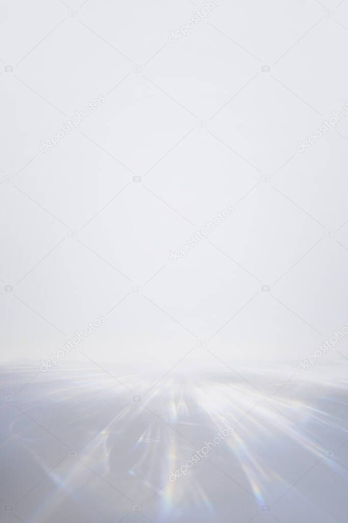 Blurred overlay effect for photo and product mockups presentation. Empty scene with white background and organic drop shadows and rays of light. Natural rainbow light refraction caustic effect.