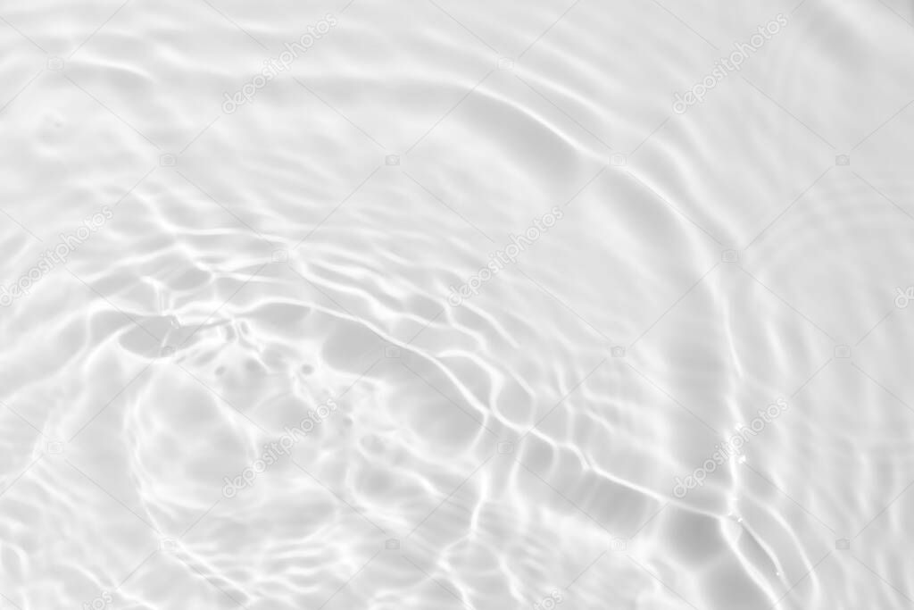 Closeup of desaturated transparent clear calm water surface texture with splashes and bubbles. Trendy abstract nature background. 
