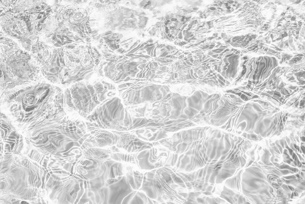 Closeup of desaturated transparent clear rough water surface texture with splashes and bubbles. Trendy abstract nature background. 