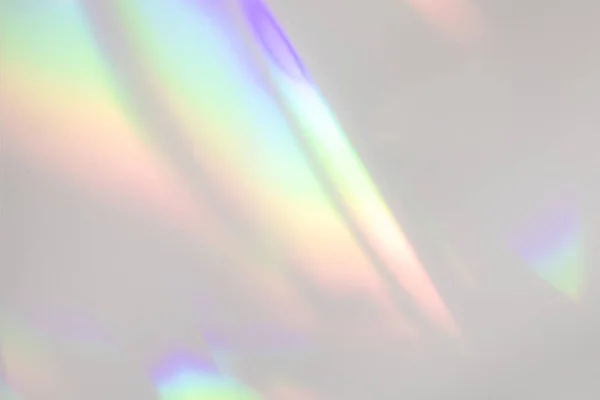 Blurred rainbow light refraction texture on white wall — Stock Photo, Image