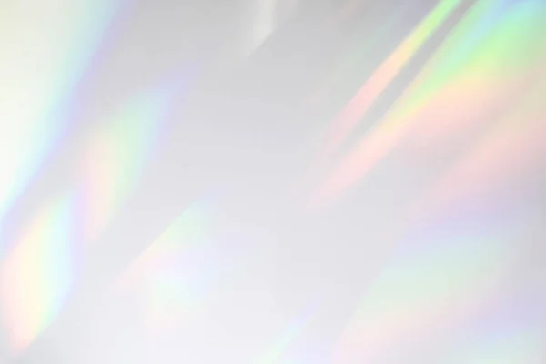 Blurred rainbow light refraction texture on white wall — Stock Photo, Image