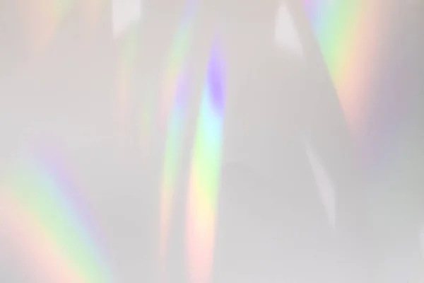 Blurred rainbow light refraction texture on white wall — Stock Photo, Image