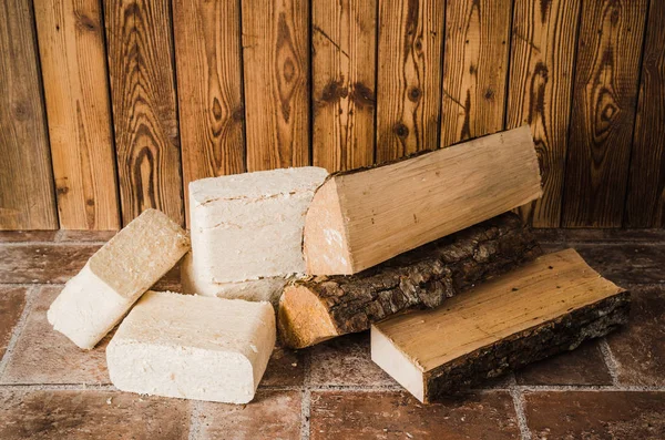 Wood briquette and firewood, close-up Stock Image