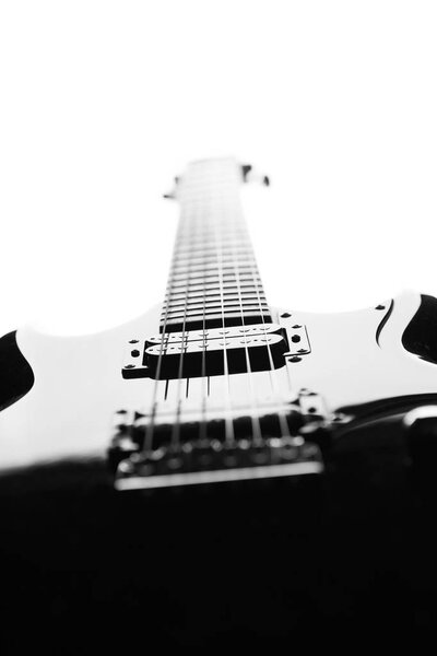 Black and white abstract silhouette of a guitar on a white background. Selective focus