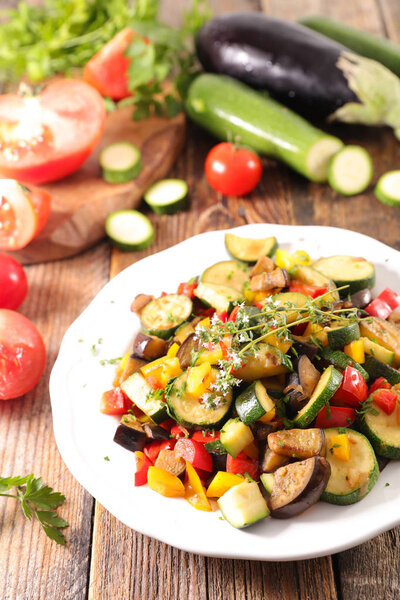 grilled vegetables and thyme on table