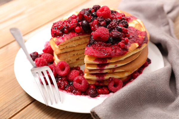 stack of pancakes with berry sauce