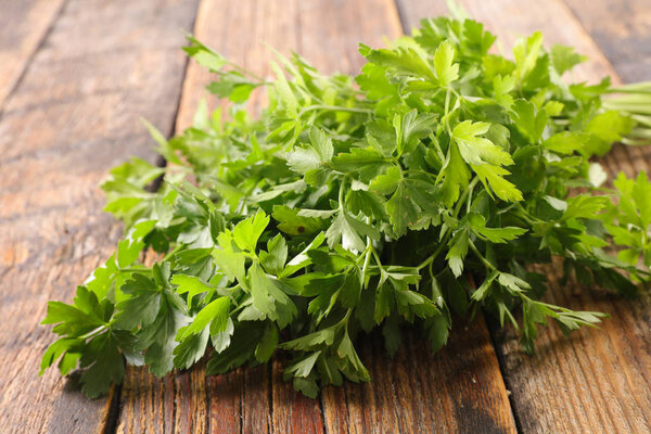 parsley on wooden background, close up view