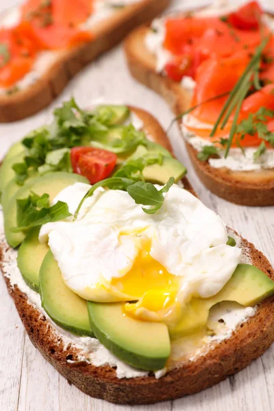 bread toast with avocado and poached egg