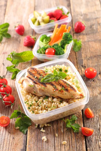 healthy meal in lunch box  on wood background