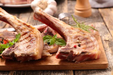 grilled lamb chop on wooden board clipart