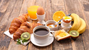 kahve, yumurta, kruvasan ve meyve kahvaltı