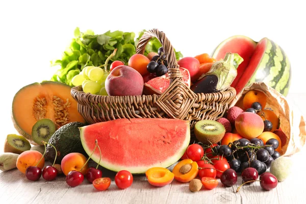 fruits and vegetables in basket on wooden table