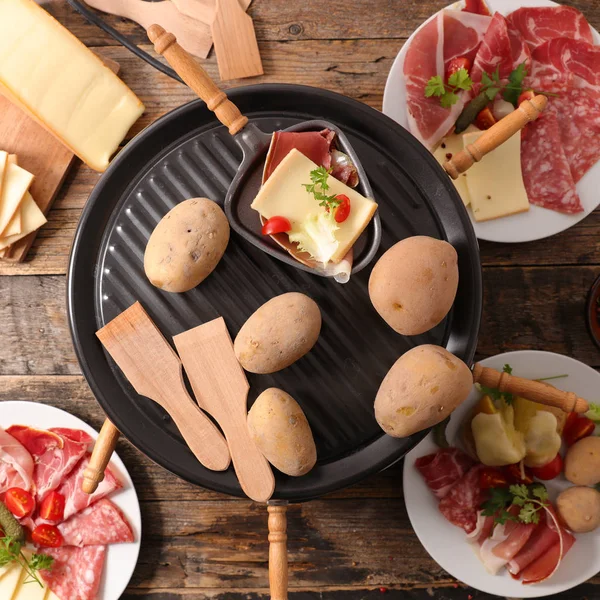 French dinner, raclette with potatoes, meat and cheese.
