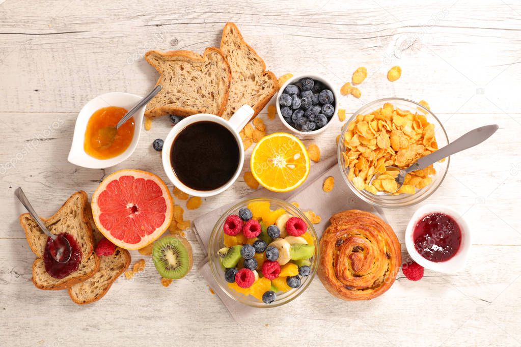 Coffee cup with fruits, cornflakes and bread