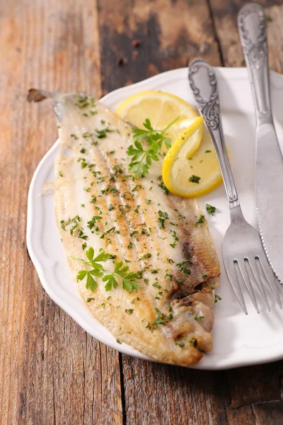 fish cooked with herbs and lemon